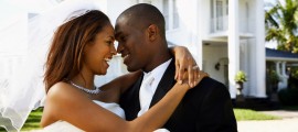 Happy Newlyweds in Front of Mansion